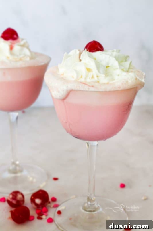 Velvet Almond Blush 2 Close up of a whipped cream topped pink squirrel cocktail.