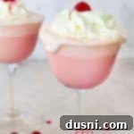 Velvet Almond Blush 18 Close up of a whipped cream topped pink squirrel cocktail.