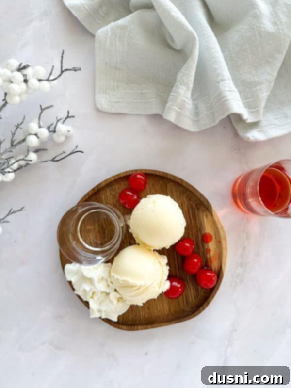 Velvet Almond Blush 7 Side view of a Pink Squirrel cocktail with whipped cream and a cherry.