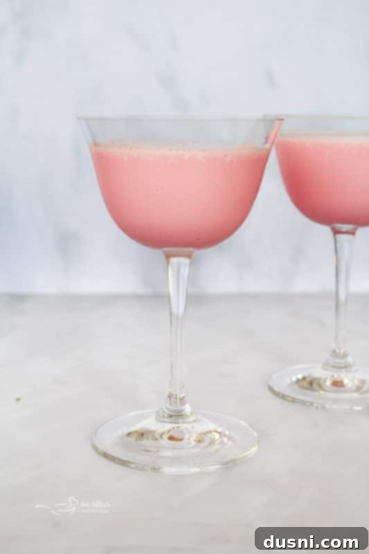 Velvet Almond Blush 9 Blended Pink Squirrel cocktail being poured into a glass.