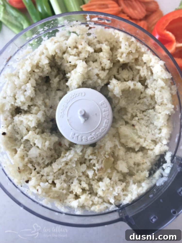 Spicy Buffalo Cauliflower Dip 9 Mixing cream cheese, sour cream, and hot sauce in a bowl