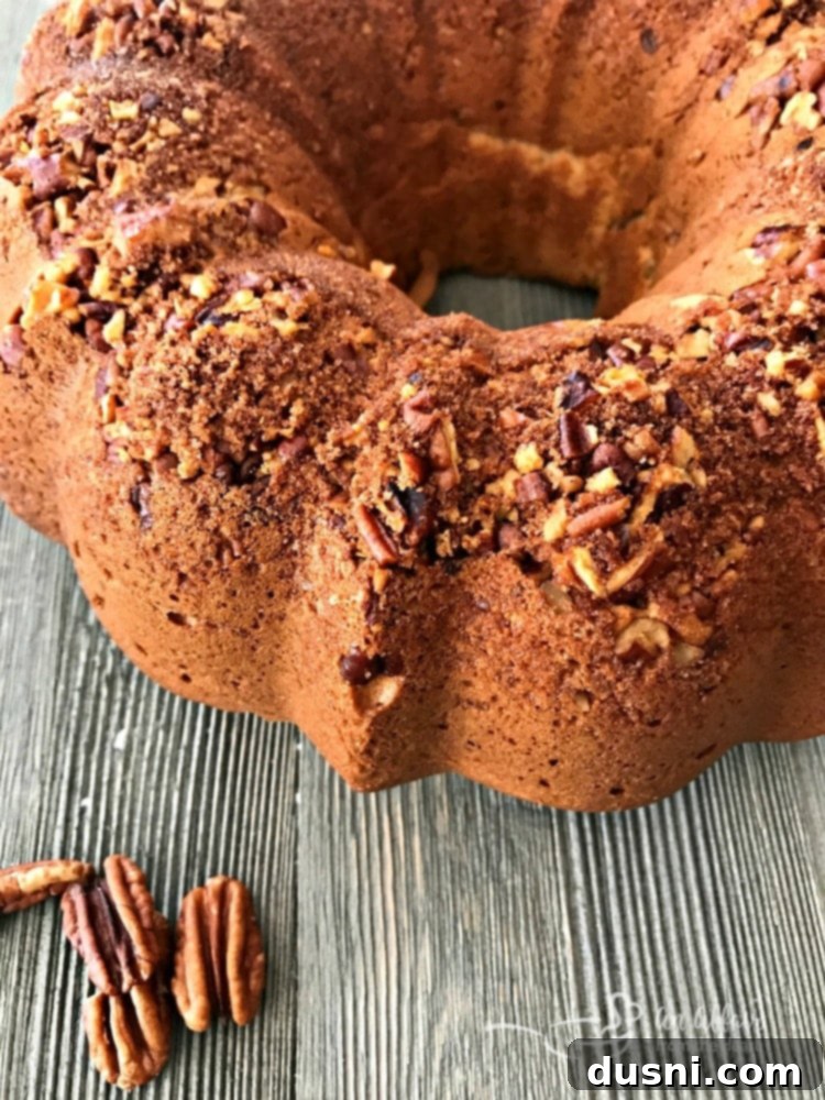 A slice of Banana Bread Coffee Cake with a golden pecan crunch topping