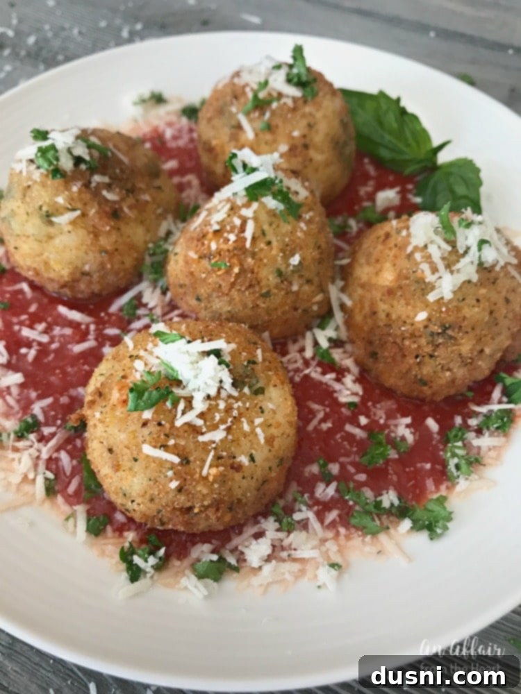 Serving Arancini - Three Cheese Fried Risotto Balls with marinara