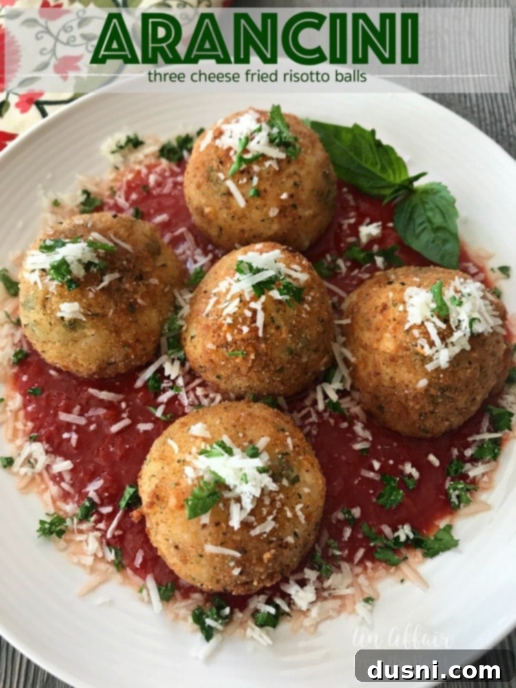 Three Arancini - Three Cheese Fried Risotto Balls on a wooden board