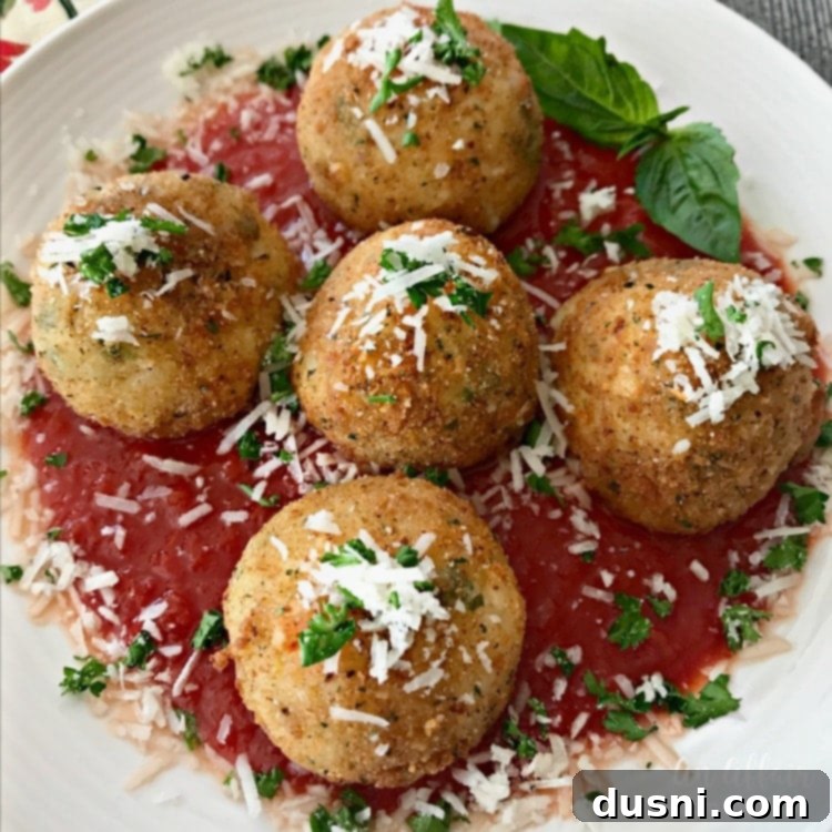 Close-up of golden brown Arancini - Three Cheese Fried Risotto Balls