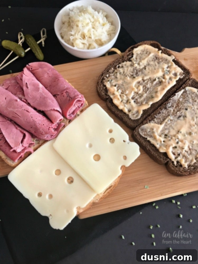 The Legendary Reuben 10 Spreading Thousand Island dressing on rye bread for a Reuben