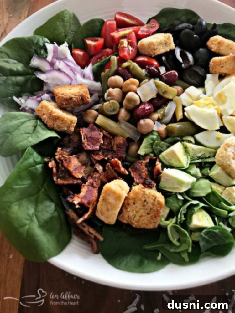 A final beautiful shot of the Loaded Spinach Salad with creamy dressing and Paisley Farm Bean Salad