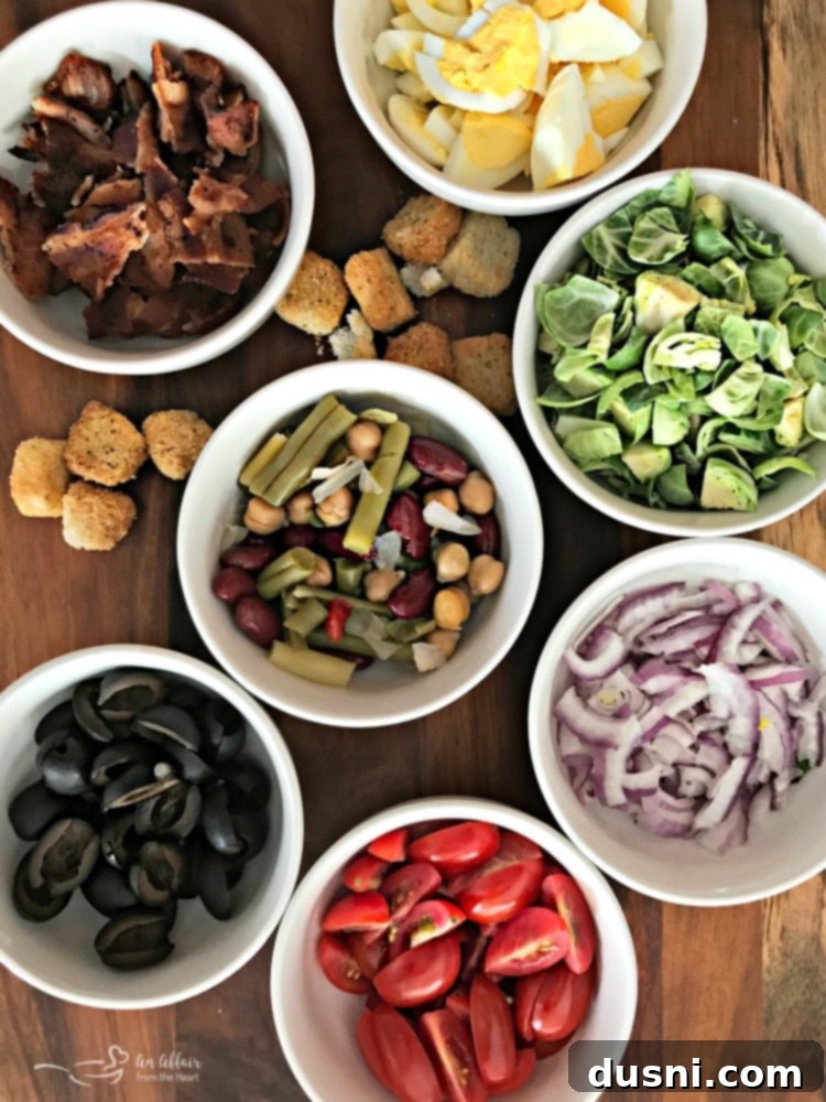 Ingredients being prepped for the Loaded Spinach Salad with Creamy Roasted Garlic Dressing