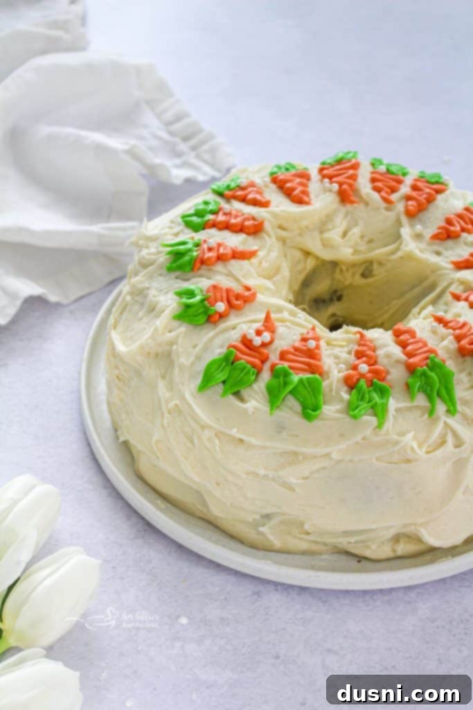 Close-up of a slice of carrot bundt cake with cream cheese frosting.