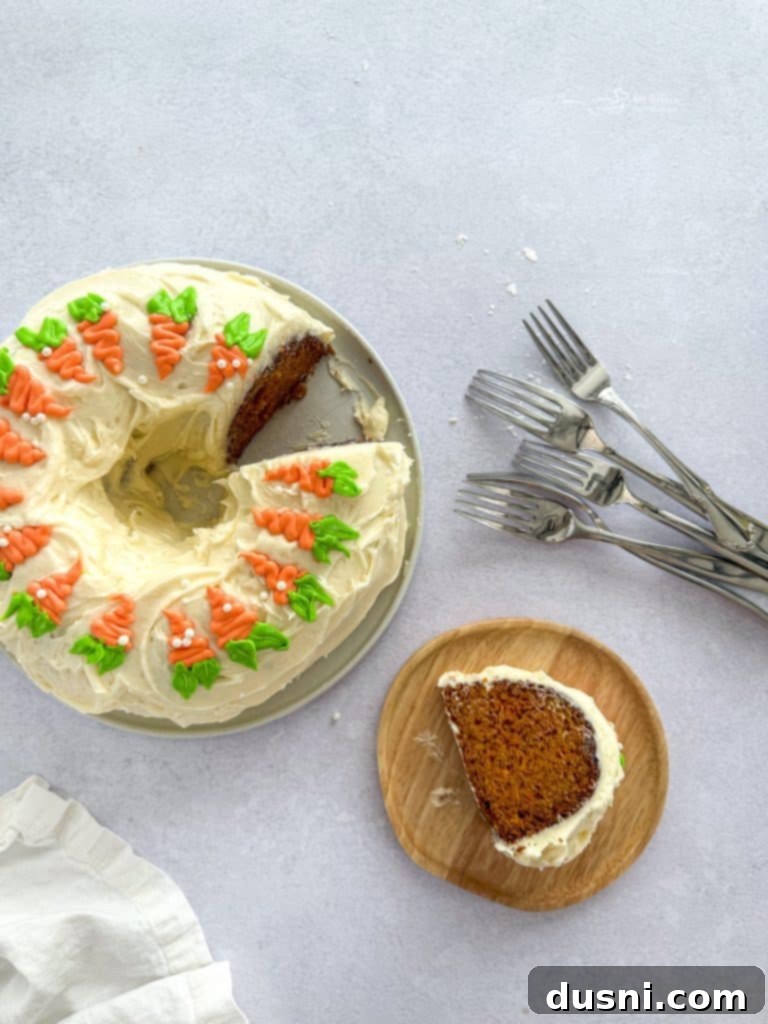 A beautifully decorated Carrot Bundt Cake with green and orange piped carrots.