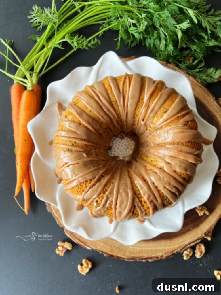 A slice of Carrot Coffee Cake with Brown Butter Glaze on a white plate.