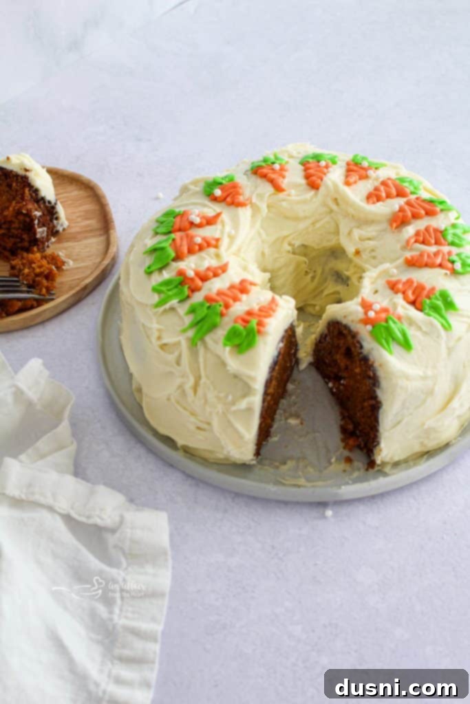 A beautifully frosted Carrot Bundt Cake with cream cheese frosting, ready to be served.