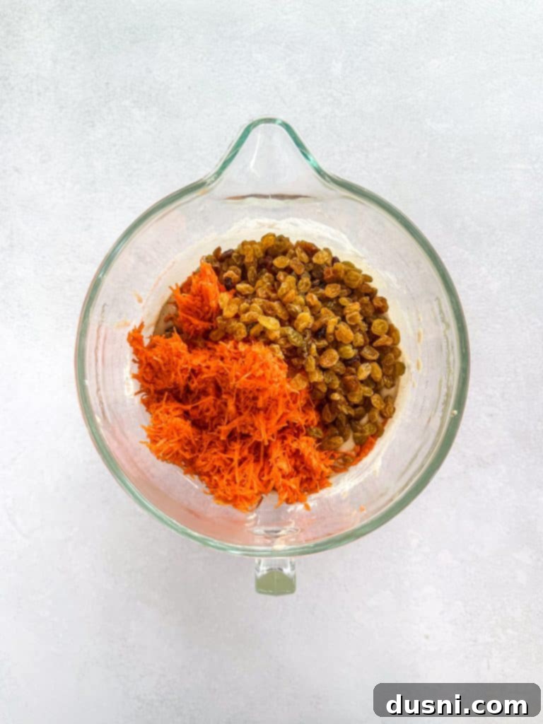 Dry ingredients being slowly incorporated into wet ingredients.