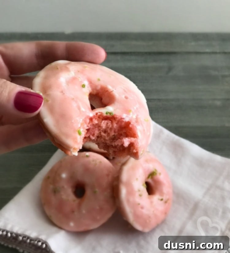 Close-up of a Cherry Limeade Baked Donut showing its fluffy pink cake interior