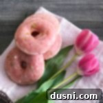 Overhead of Cherry Limeade Baked Donuts and tulips on a white cloth napkin