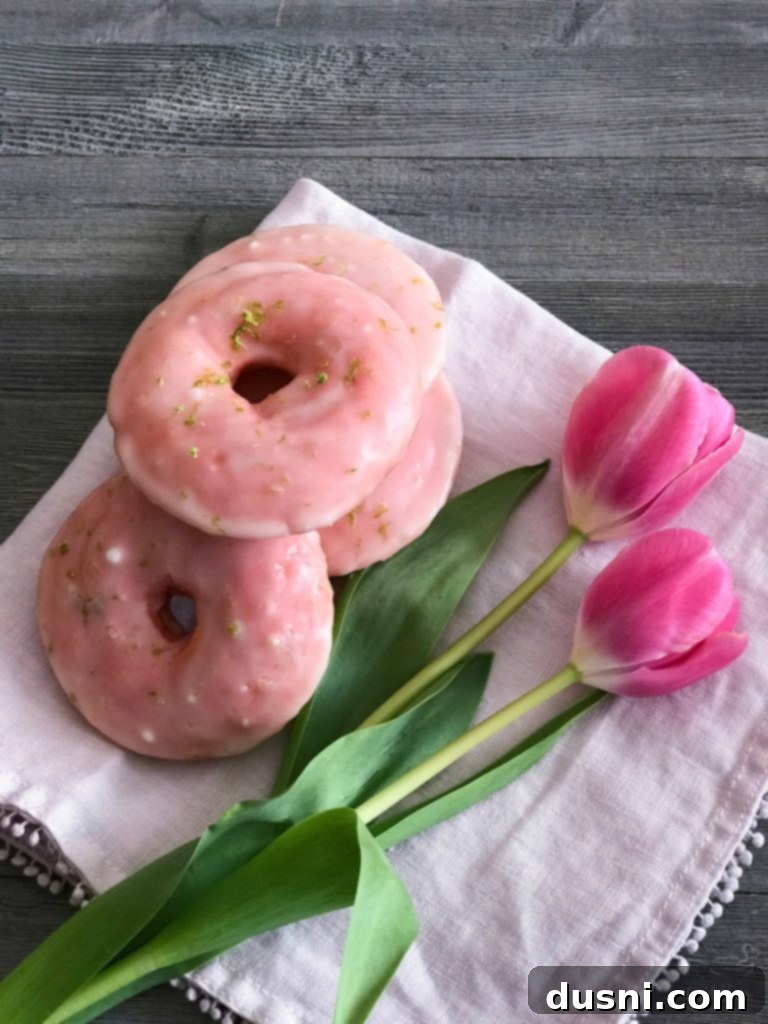 Close up overhead shot of Cherry Limeade Baked Donuts with tulips in the background