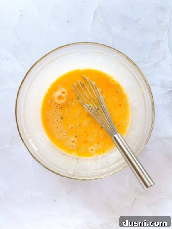 Beaten egg mixture poured over casserole ingredients