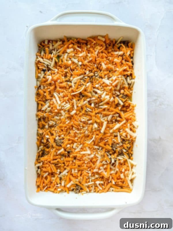 Shredded cheese sprinkled over the breakfast casserole