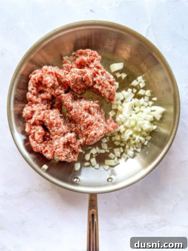 Browning sausage with onions in a large skillet