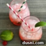 Overhead shot of two glasses of Sonic Cherry Limeade with lime slices and cherries