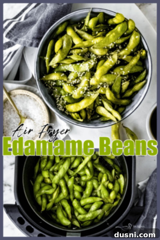 Finished air fryer edamame beans in a bowl with soy sauce and sesame seeds