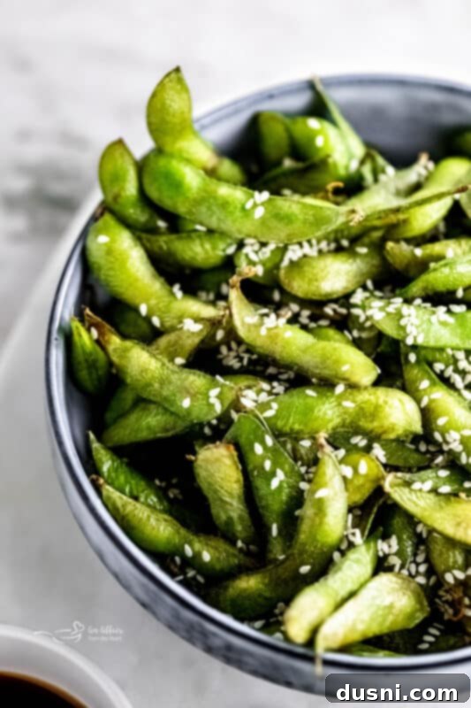 Air fryer edamame beans in a bowl with chopsticks