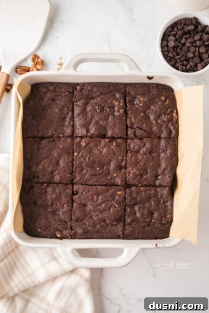A freshly baked pan of fudgy pecan brownies, still warm from the oven.