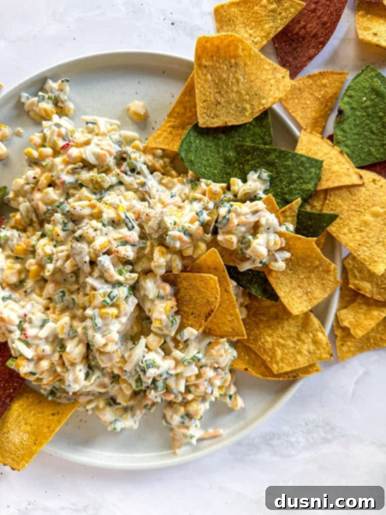 Award Winning Crack Dip and tortilla chips on a white plate.