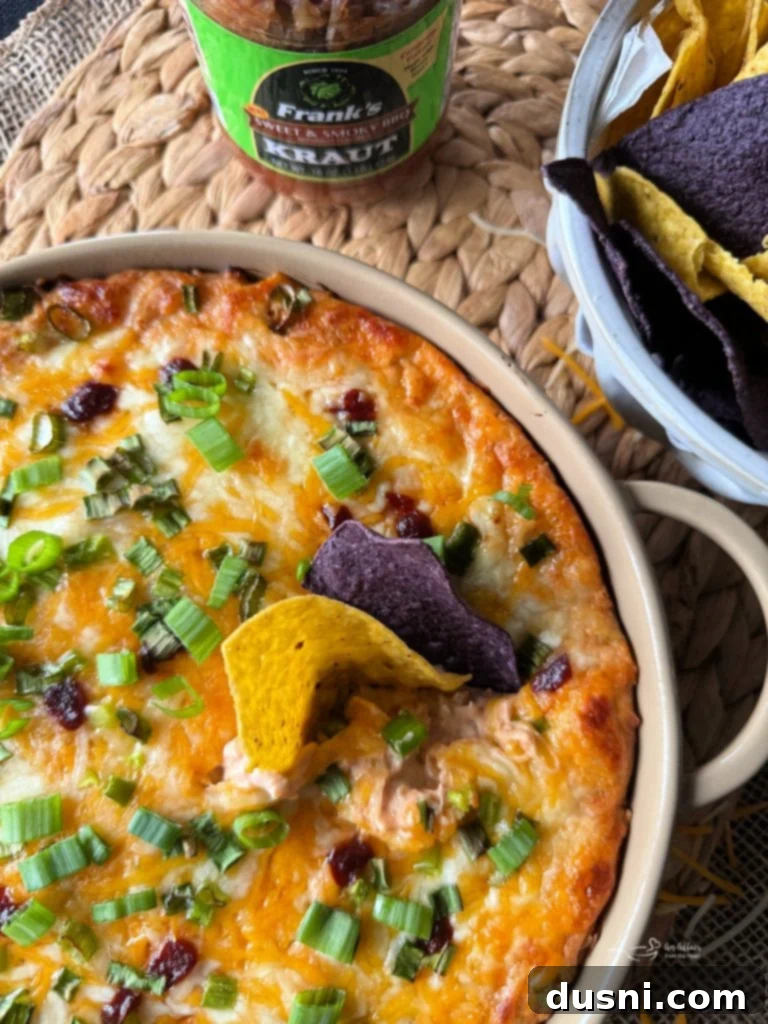 Close up shot of BBQ Chicken Dip with Kraut served with tortilla chips.