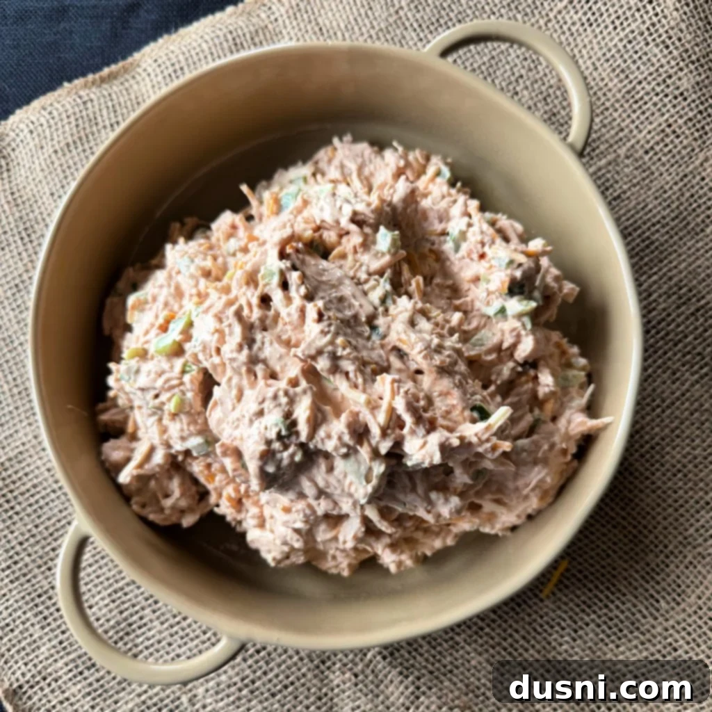 Close up shot of the ingredients being mixed together for the BBQ Chicken Dip with Kraut.