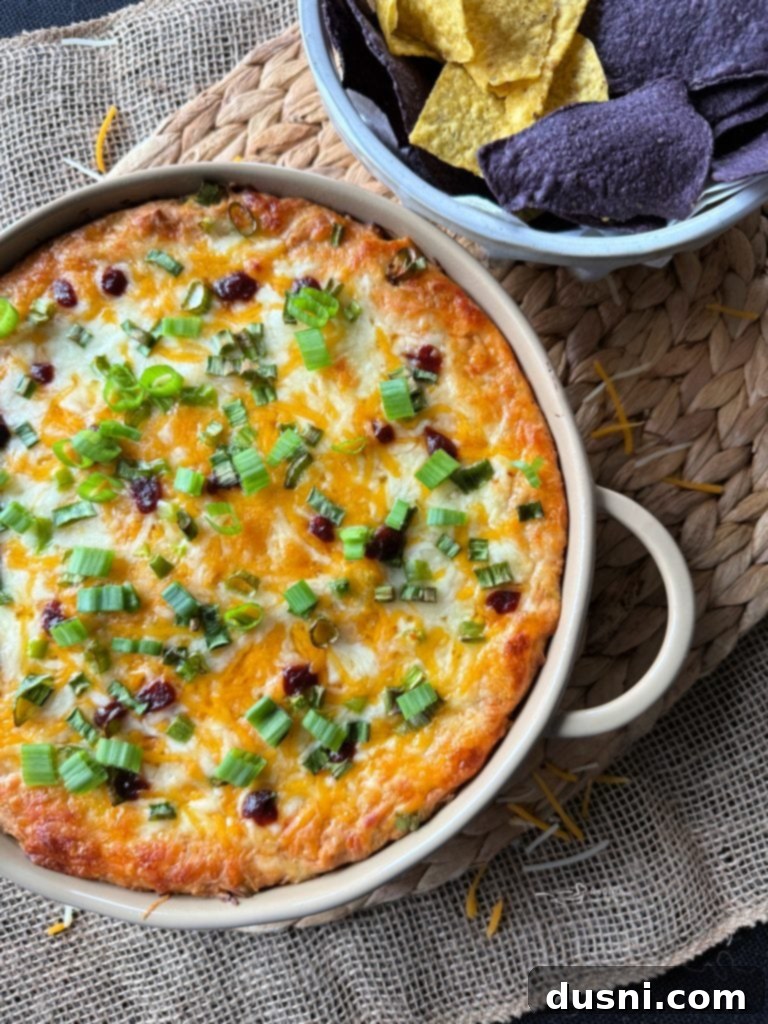 Baked BBQ Chicken Dip with Kraut with bubbly cheese.